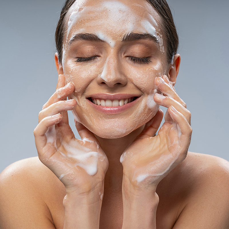 woman cleansing face